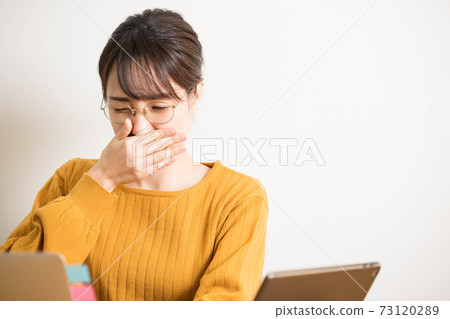 A young woman who has a runny nose due to hay fever A young woman who has a runny nose due to hay fever 73120289