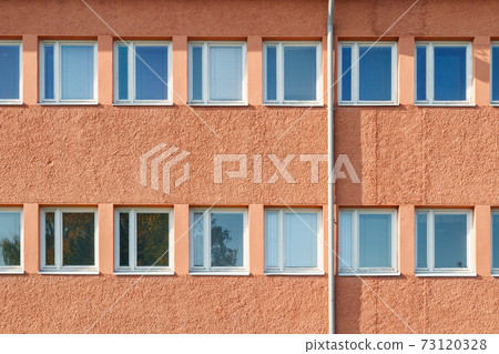 Facade of a building with rows of windows 73120328