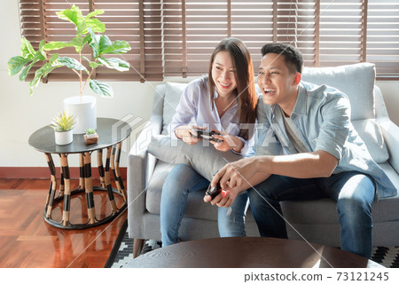 Asian couple lovers enjoy and play console game on vacation  73121245