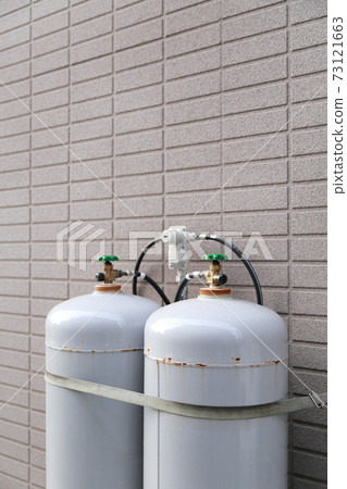 Propane gas cylinder installed outdoors in a house Propane gas cylinder installed outdoors in a house 73121663
