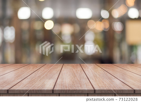 Empty wooden table top with lights bokeh on blur restaurant background. Empty wooden table top with lights bokeh on blur restaurant background. 73122028