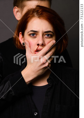 Desparate young woman with aggressive man in studio, domestic violence conception Desparate young woman with aggressive man in studio, domestic violence conception 73122133