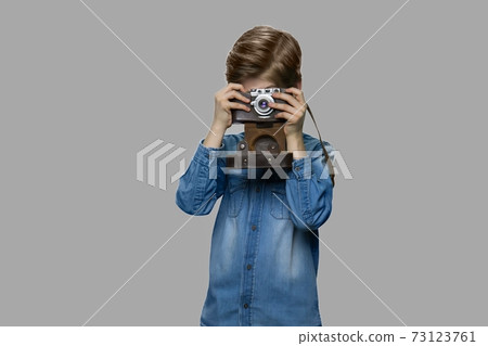 Little boy using old retro camera. 73123761