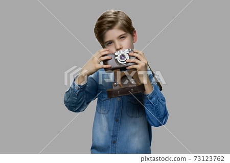 Little boy using vintage camera. 73123762