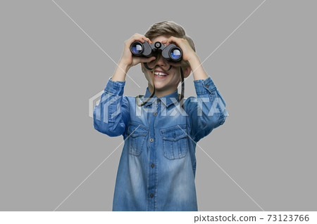 Little boy looking through binoculars. 73123766