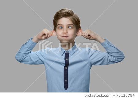 Caucasian boy making monkey face. 73123794