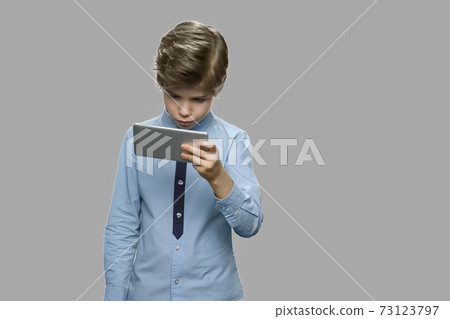 Handsome caucasian boy using smartphone. Handsome caucasian boy using smartphone. 73123797