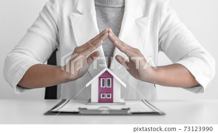 Sales manager or real estate agent prepares to hand over the house together with the insurance, Attention to property services and insurance concept. Sales manager or real estate agent prepares to hand over the house together with the insurance, Attention to property services and insurance concept. 73123990