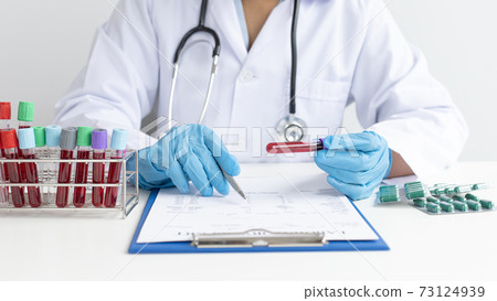 Scientists or physicians analyze the blood sample in vitro to prepare a vaccine against a new strain of viruses, Examination with blood test tubes, Vaccine Research and Science concept. Scientists or physicians analyze the blood sample in vitro to prepare a vaccine against a new strain of viruses, Examination with blood test tubes, Vaccine Research and Science concept. 73124939