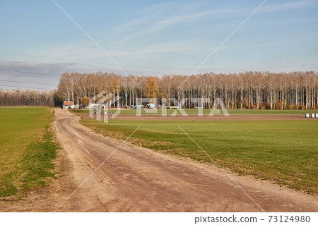 Agircutural field with dirt road Agircutural field with dirt road 73124980