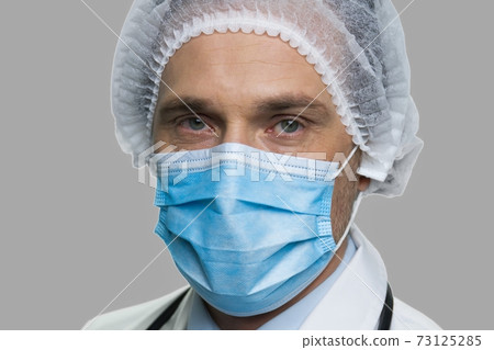Close up male doctor in face mask. Close up male doctor in face mask. 73125285