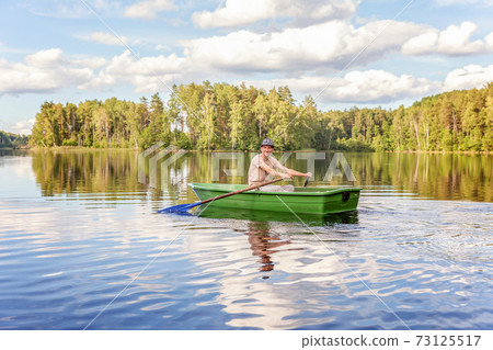 Fisherman in a boat 73125517