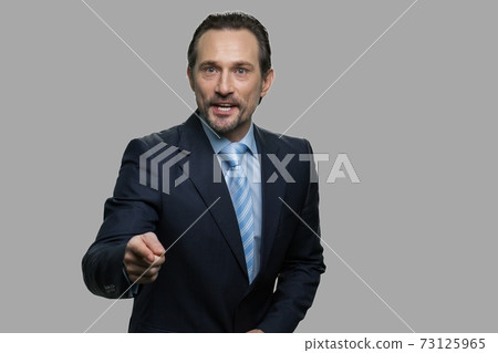 Aggressive businessman shouting and pointing to camera. Aggressive businessman shouting and pointing to camera. 73125965