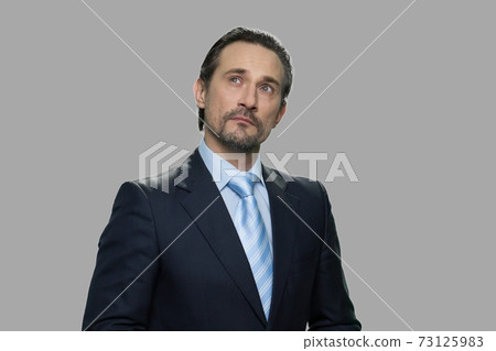 Portrait of confident businessman with thoughtful expression. Portrait of confident businessman with thoughtful expression. 73125983