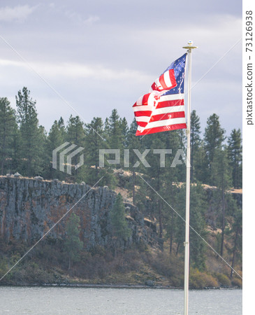 The American Flag flying over Williams Lake in Cheney, Spokane County, Washington 73126938