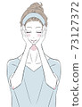 A woman who puts her hand on her face and does skin care 73127372