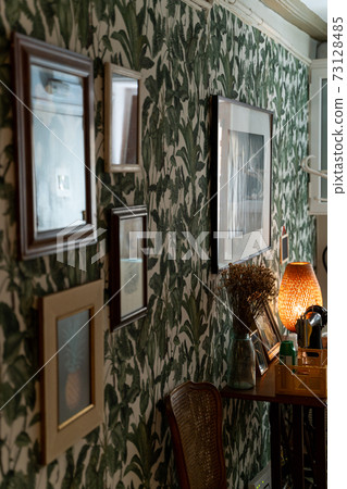 Sewing machine, hourglass and lamp with wallpaper in floral tropical pattern 73128485