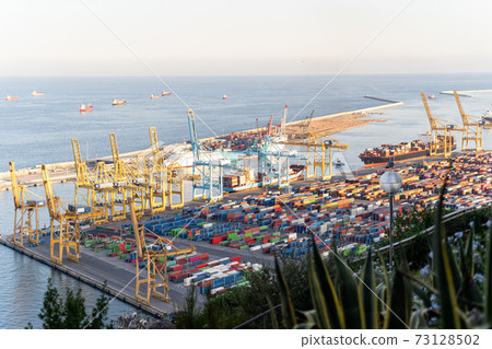 Aerial view to a sea cargo port with containers, cranes and ships in Barcelona Aerial view to a sea cargo port with containers, cranes and ships in Barcelona 73128502