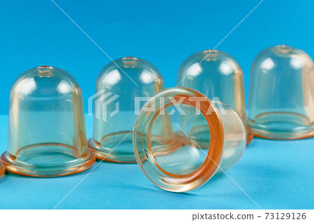 Medical transparent silicone jars for massage and treatment on a blue background 73129126