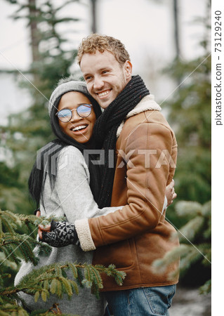 Mixed couple choosing a christmas tree 73129240