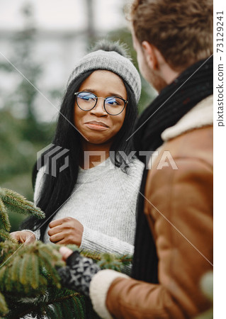 Mixed couple choosing a christmas tree 73129241