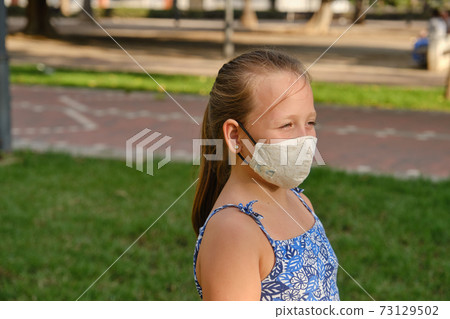 girl in a cloth mask in the Park 73129502