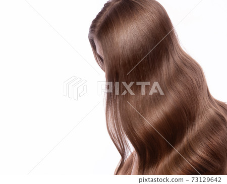 Portrait of beautiful brown-haired woman with a perfectly curls hair, and classic make-up. 73129642