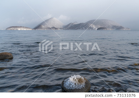 Lake Toya, an island covered with snow 73131076