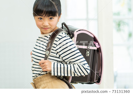 Elementary school student carrying a school bag - Stock