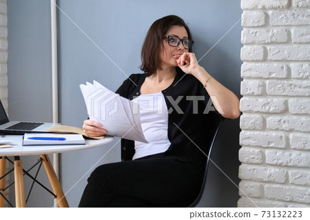 Mature woman working in home office, female... - Stock Photo [73132223