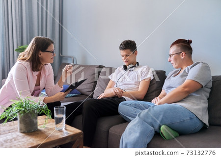Mother with her teenage son at meeting with social worker, psychologist 73132776
