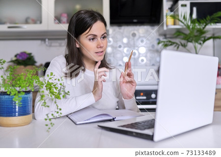 Young female working in home office using laptop, business woman, teacher Young female working in home office using laptop, business woman, teacher 73133489