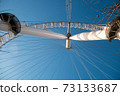 London Eye Ferris Wheel with a Blue Sky 73133687