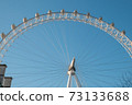 London Eye Ferris Wheel with a Blue Sky 73133688