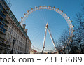 London Eye Ferris Wheel with a Blue Sky 73133689