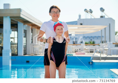 Family, sport, swimming, health, lifestyle concept. Portrait of mom and kid daughter 73134769