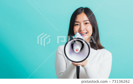 woman smile she holding megaphone making the announcement woman smile she holding megaphone making the announcement 73136262