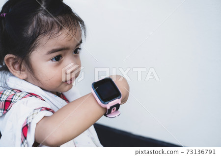 Asian kid use technology smart watches with happy faces Asian kid use technology smart watches with happy faces 73136791
