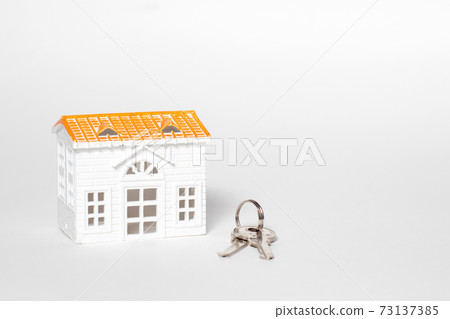 Toys small house and keys on isolated white background Toys small house and keys on isolated white background 73137385