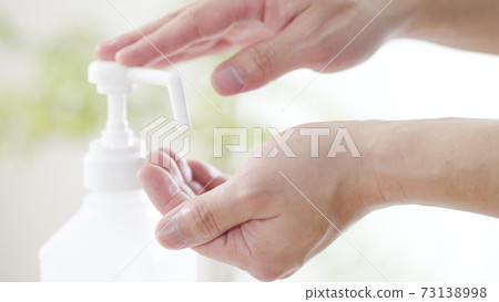 Men doing alcohol disinfection Men doing alcohol disinfection 73138998