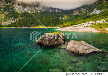 Stunning alpine lake and foggy mountains,Hinterer Gosausee,Austria 73139993