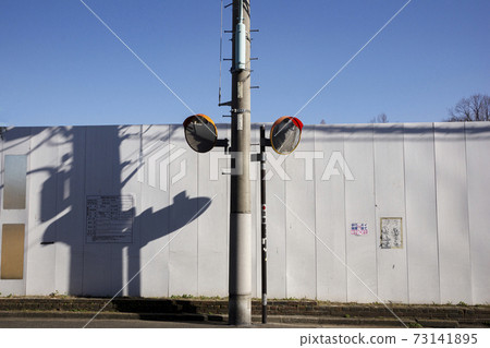 White temporary wall for construction, road mirror and shadow 73141895