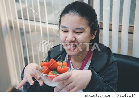 Woman eat strawberry red berry fruit sweet juicy Woman eat strawberry red berry fruit sweet juicy 73142114