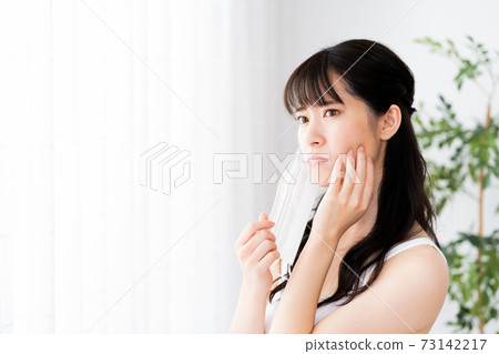 Young woman suffering from mask trouble Young woman suffering from mask trouble 73142217
