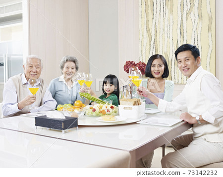 happy three-generation family having meal at home 73142232