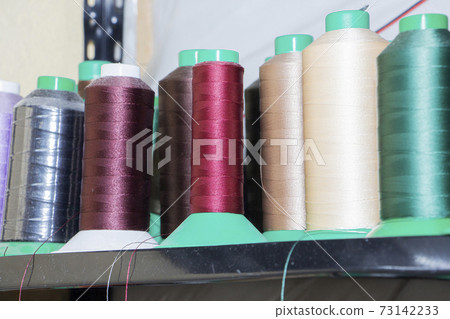 Colorful reels with threads, backgrounds, images related to the tailor. Colorful reels with threads, backgrounds, images related to the tailor. 73142233