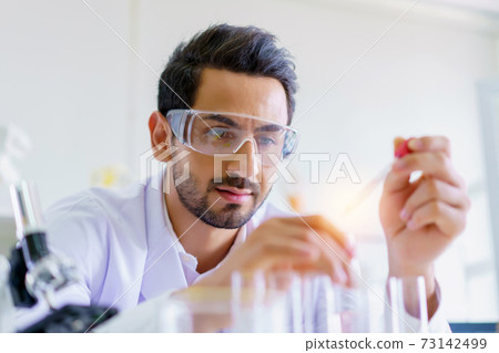 Doctor and microbiologist with vacuum tubes for samples with COVID 19 infection atypical pneumonia virus in laboratory Doctor and microbiologist with vacuum tubes for samples with COVID 19 infection atypical pneumonia virus in laboratory 73142499