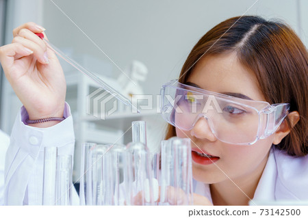Doctor and microbiologist with vacuum tubes for samples with COVID 19 infection atypical pneumonia virus in laboratory Doctor and microbiologist with vacuum tubes for samples with COVID 19 infection atypical pneumonia virus in laboratory 73142500
