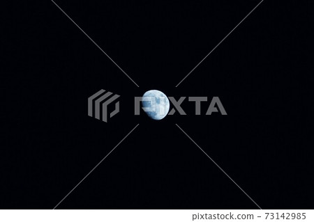 The moon floating in the pitch-black night sky 73142985