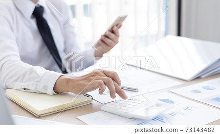 Accounting businessmen are calculating income-expenditure and analyzing real estate investment data, Dedicated to the progress and growth of the company, Financial and tax systems concept. Accounting businessmen are calculating income-expenditure and analyzing real estate investment data, Dedicated to the progress and growth of the company, Financial and tax systems concept. 73143482